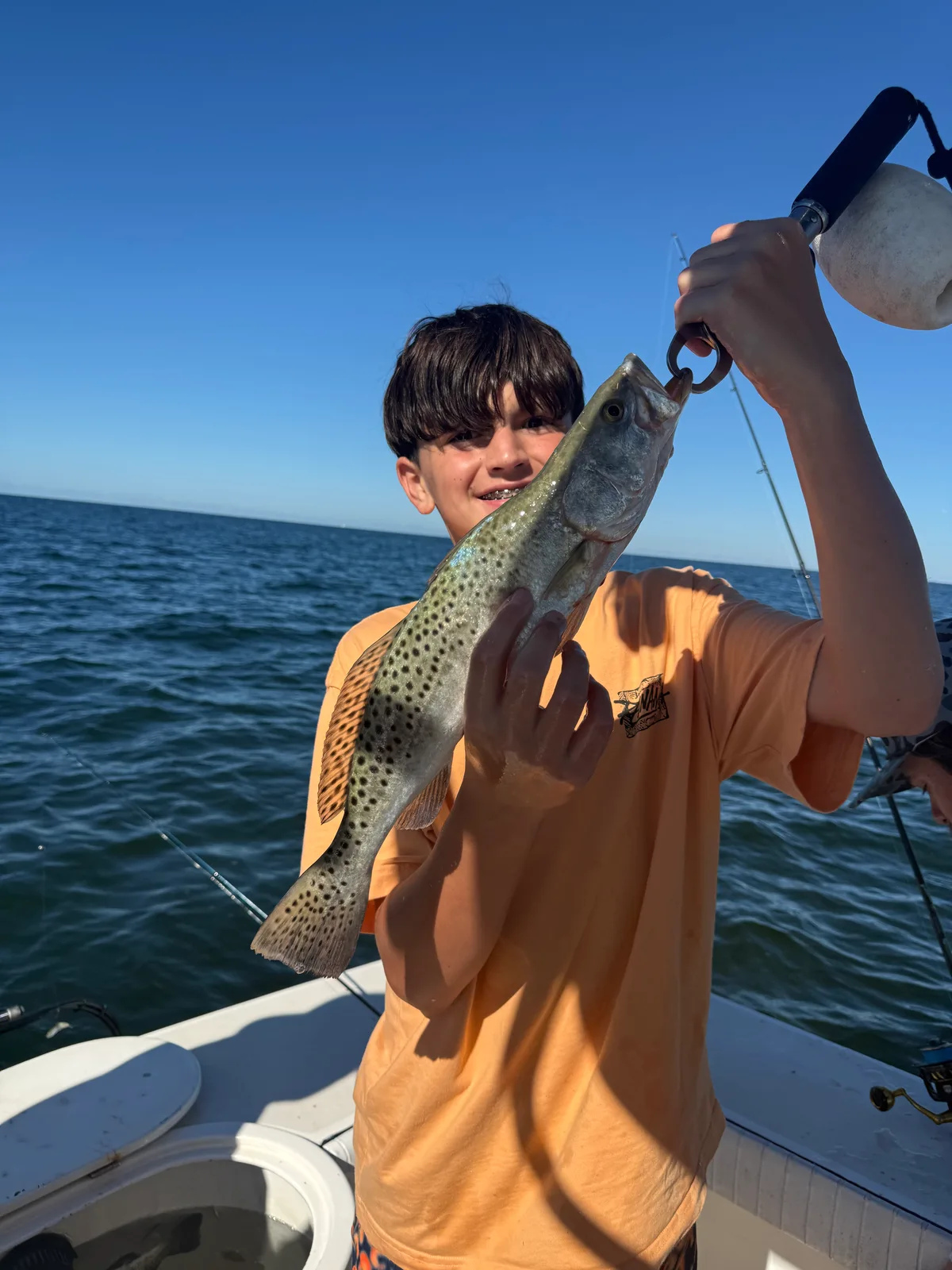 Young angler displays a Spanish mackerel on a Sarasota fishing trip — October 15, 2026.