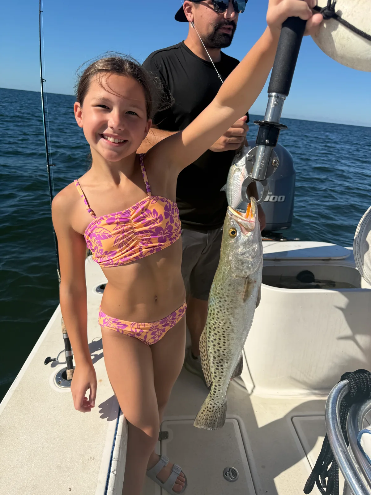 Young angler holds a Spanish mackerel aboard a Sarasota fishing trip — October 15, 2026.